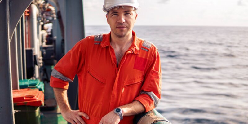 Man with safety helmet on deck