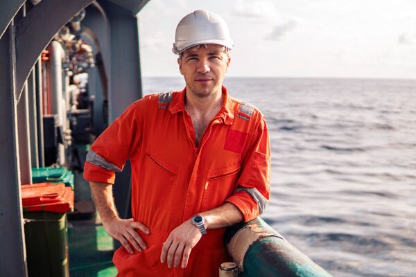 Man with safety helmet on deck