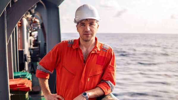 Man with safety helmet on deck 