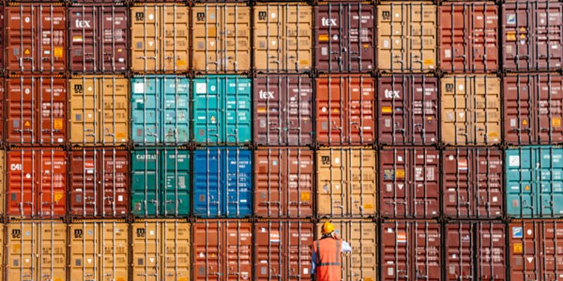 Man standing in front of containers