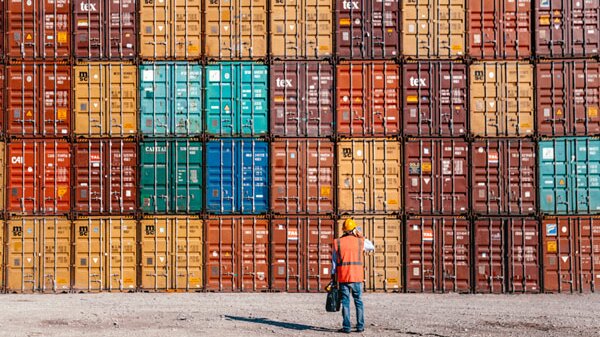 Man standing in front of containers