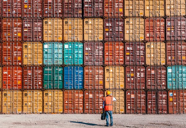 Man standing in front of containers